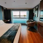A beautifully appointed royal cabin on the MS Miriam nile cruise ship featuring a large bed and panoramic river views
