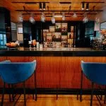 The stylish and well-stocked main bar with comfortable blue bar stools on the elegant MS Miriam Nile Cruise The stylish and well-stocked main bar with comfortable blue bar stools on the elegant MS Miriam Nile Cruise