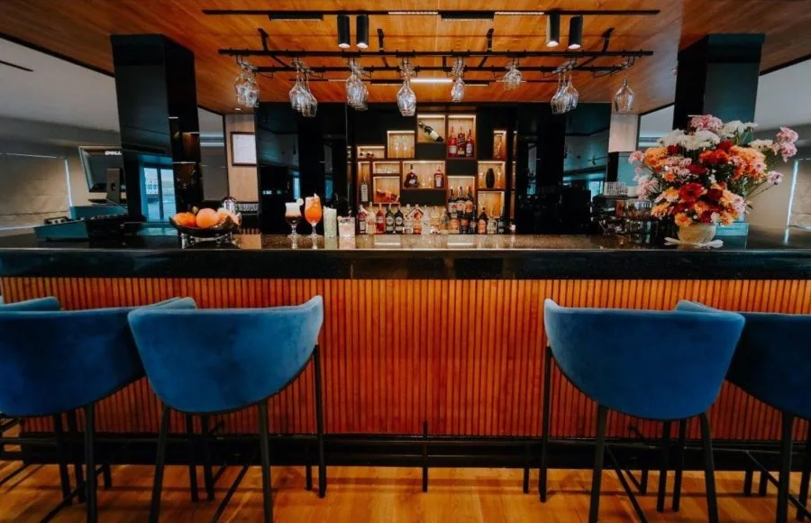 The stylish and well-stocked main bar with comfortable blue bar stools on the elegant MS Miriam Nile Cruise The stylish and well-stocked main bar with comfortable blue bar stools on the elegant MS Miriam Nile Cruise