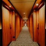 The brightly lit and elegantly paneled cabin corridor aboard the luxury MS Miriam nile cruise ship