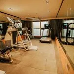 A fully equipped gym with treadmills and exercise machines overlooking the Nile river on the MS Miriam Nile Cruise