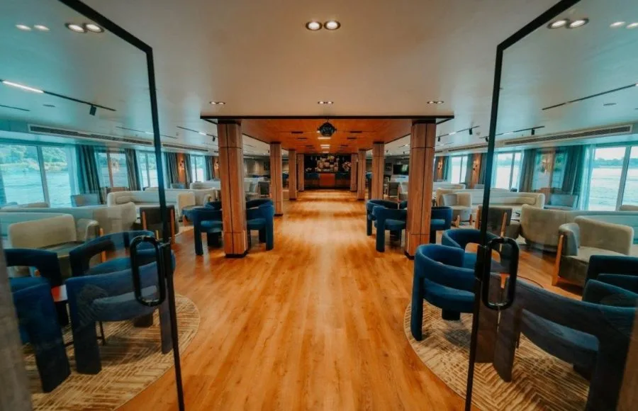 The expansive main lounge and bar area of the luxury MS Miriam nile cruise ship with ample seating and river views