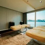 A tranquil massage room with treatment tables and a panoramic window view of the Nile river on the MS Miriam nile cruise ship