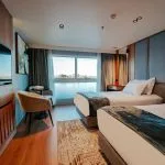 A beautifully designed twin cabin on the MS Miriam Nile Cruise offering comfortable beds and large windows with river views