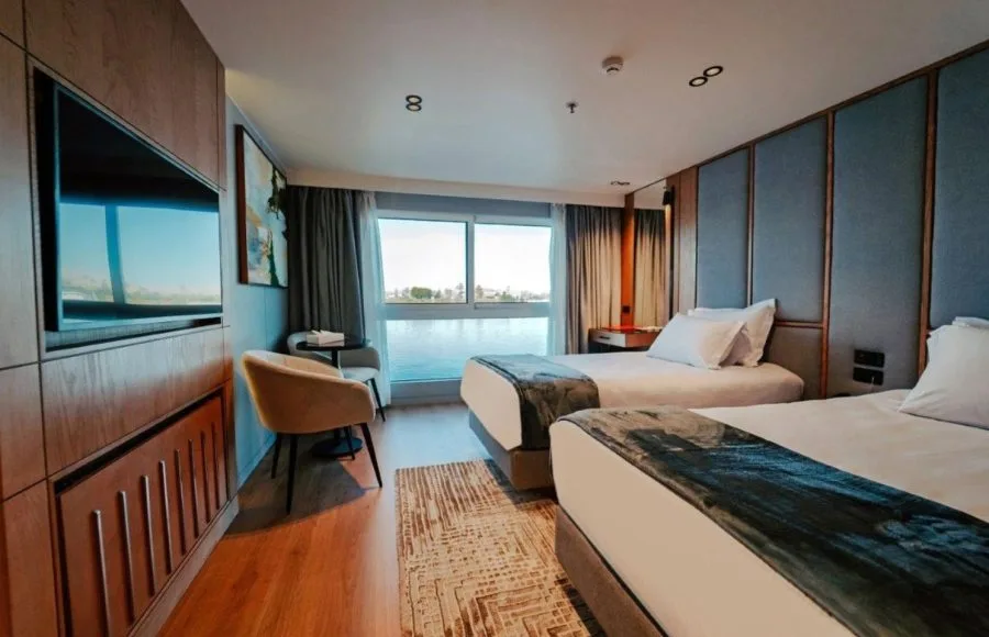 A beautifully designed twin cabin on the MS Miriam Nile Cruise offering comfortable beds and large windows with river views