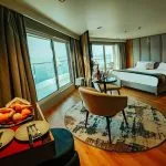 The lavishly appointed suite on the MS Miriam nile cruise ship featuring a king-size bed and large windows overlooking the Nile