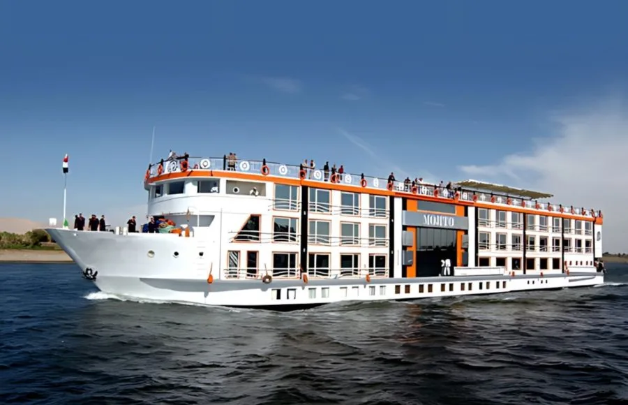Exterior of Nile cruise ship docked, featuring orange and white facade.