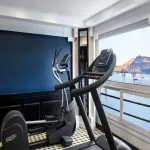 The onboard gymnasium of the Movenpick Hamees Nile Cruise allows guests to exercise while enjoying panoramic river and scenic landscape views.