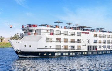 Movenpick Hamees Nile Cruise on the water under a clear blue sky offers luxurious views and a classic silhouette.