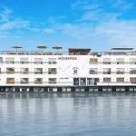 The impressive Movenpick Hamees Nile Cruise sails calmly, showcasing its elegant design under a bright sky.