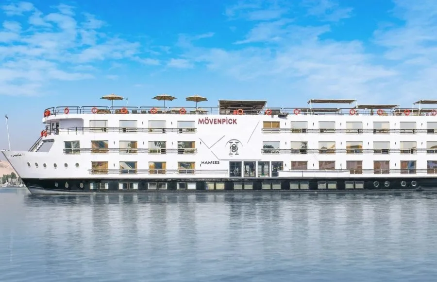 The impressive Movenpick Hamees Nile Cruise sails calmly, showcasing its elegant design under a bright sky.