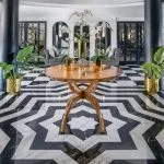 The opulent lobby of the Movenpick Hamees Nile Cruise features a striking black and white marble floor and elegant modern design