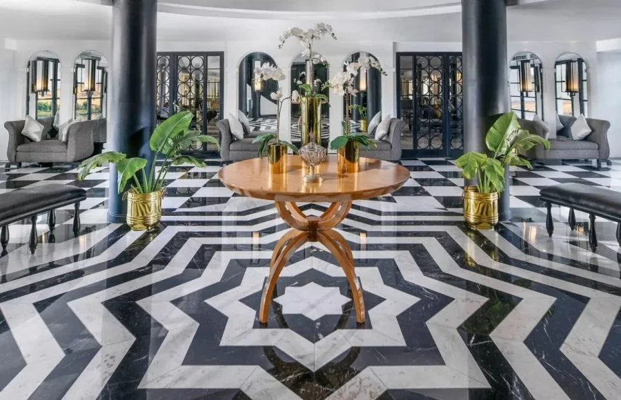 The opulent lobby of the Movenpick Hamees Nile Cruise features a striking black and white marble floor and elegant modern design