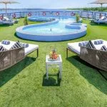 The beautiful outdoor pool and sun loungers on the upper deck of the luxury Movenpick Hamees Nile Cruise offering refreshing views of the river.