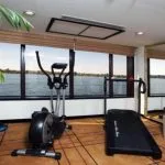 The bright gymnasium onboard the Movenpick Royal Lily Nile Cruise with panoramic river views