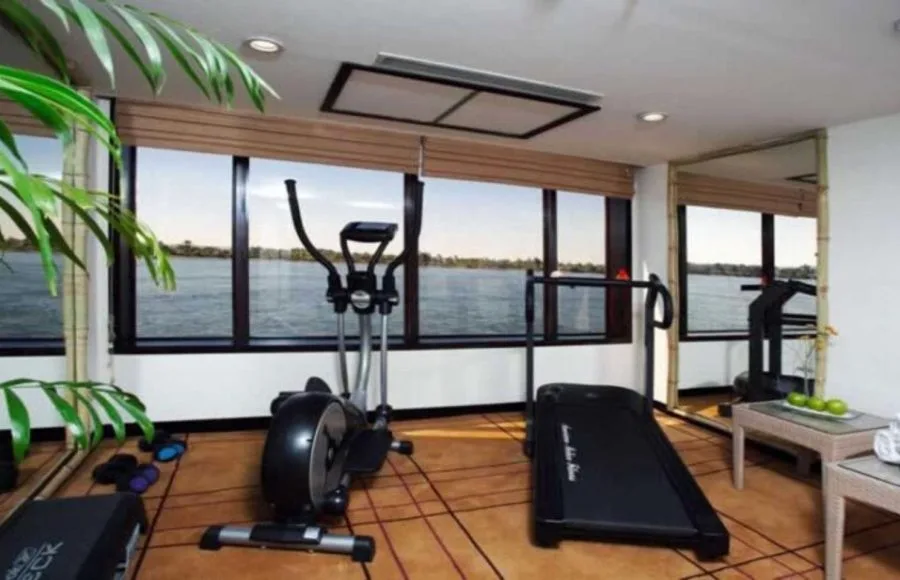 The bright gymnasium onboard the Movenpick Royal Lily Nile Cruise with panoramic river views