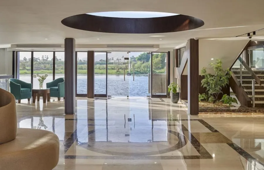 The elegant lobby of the Movenpick Royal Lily Nile Cruise with large windows overlooking the river