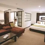 Luxurious suite with a large bed and sofa on the Movenpick Royal Lily Nile Cruise offering comfort