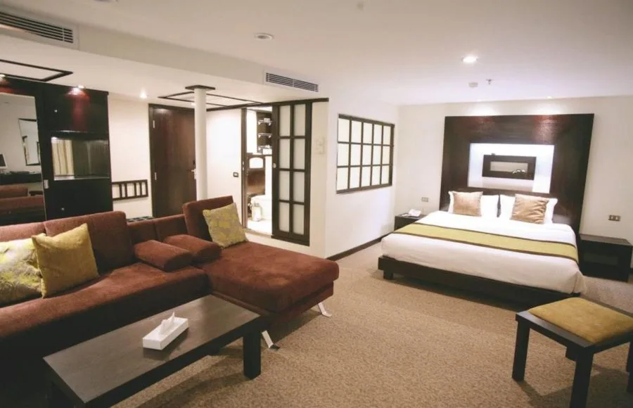 Luxurious suite with a large bed and sofa on the Movenpick Royal Lily Nile Cruise offering comfort