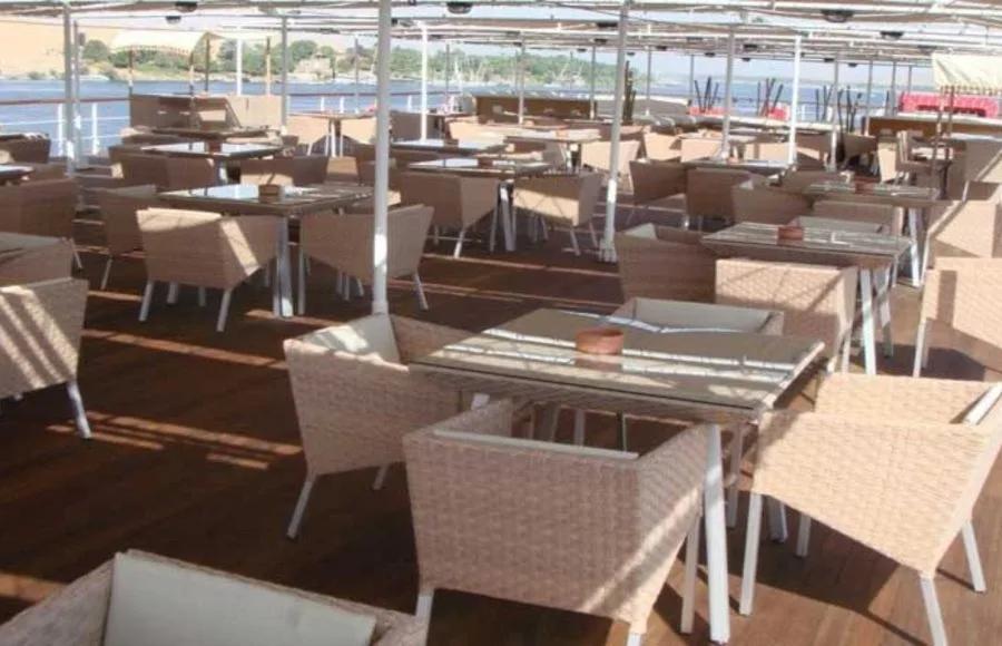 Outdoor dining on the sun deck of the Movenpick Royal Lily Nile Cruise with river scenery