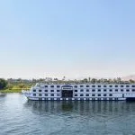 The stunning white exterior of the mövenpick ms royal lotus nile cruise sails smoothly along the Nile River