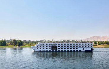The stunning white exterior of the mövenpick ms royal lotus nile cruise sails smoothly along the Nile River
