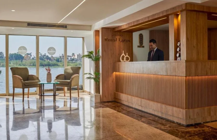 The bright and elegant reception desk on the Ms Royal Lotus Nile Cruise with a staff member ready to assist