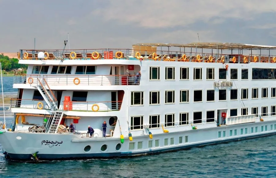 Multi-deck exterior of the luxurious ms nile premium cruise ship sailing on the Nile River under a bright sky.