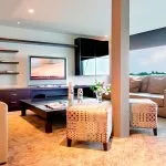 Cozy reading lounge and relaxation area with comfortable seating, a television, and bookshelves on the Ms Premium Nile Cruise ship.