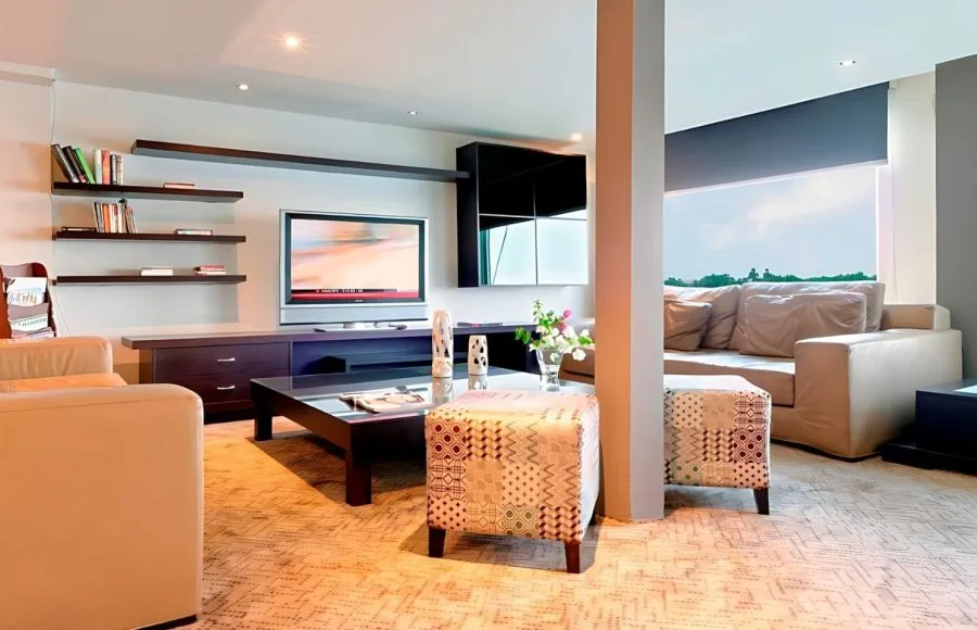 Cozy reading lounge and relaxation area with comfortable seating, a television, and bookshelves on the Ms Premium Nile Cruise ship.