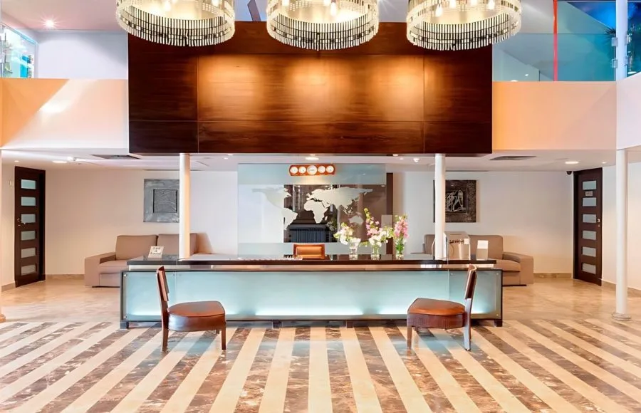 The modern and elegant reception desk of the Ms Nile Premium cruise ship with a glowing front and world map detailing time zones.