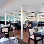 Spacious and elegantly set dining room aboard the Ms Nile Premium cruise ready to serve exquisite meals.