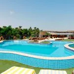 Sun-drenched swimming pool on the sundeck of the luxurious Ms Nile Premium cruise ship offering a relaxing spot with lounge chairs and views of the riverbank