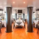 The spacious and elegant main restaurant of the MS Nile Style Cruise Ship, ready for dining.