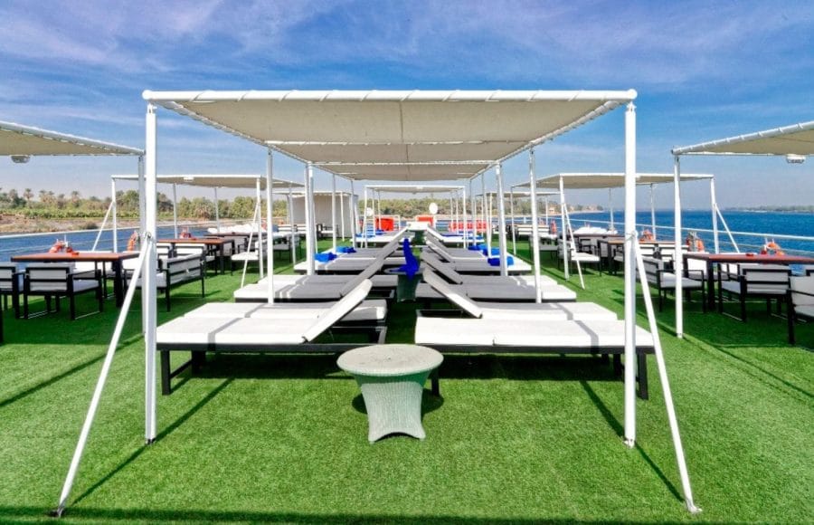 The spacious and shaded sun deck of the MS Nile Style Cruise Ship, perfect for relaxing by the river.