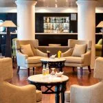 The cozy and stylish main lounge area aboard the MS Nile Style Cruise Ship with a bar in the background.