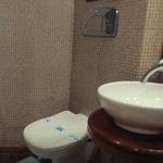 A clean and modern bathroom with a sink, toilet, and shower cabin on the Princess Sarah I Nile Cruise.