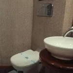 A clean and modern bathroom with a sink, toilet, and shower cabin on the Princess Sarah I Nile Cruise.