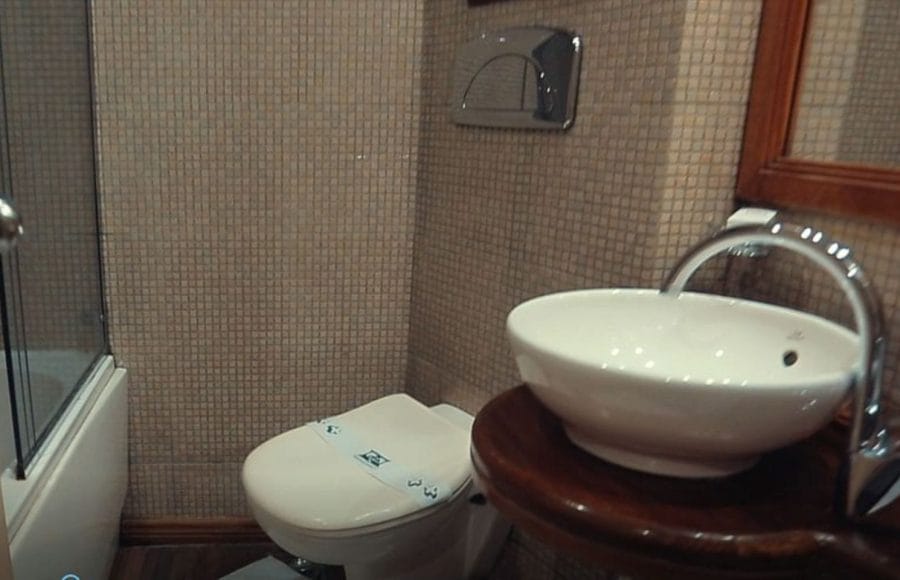 A clean and modern bathroom with a sink, toilet, and shower cabin on the Princess Sarah I Nile Cruise.