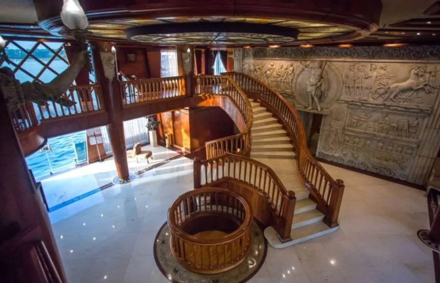 The elegant lobby of the Princess Sarah I Nile Cruise featuring rich wooden paneling and luxurious decor.