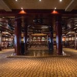 A spacious entertainment lounge with a stage, bar, and seating areas on the Princess Sarah I Nile Cruise.