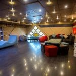 A contemporary lounge area with colorful seating, bean bags, on the Princess Sarah I Nile Cruise.