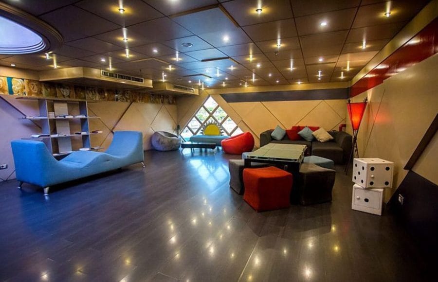A contemporary lounge area with colorful seating, bean bags, on the Princess Sarah I Nile Cruise.