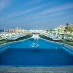 The illuminated swimming pool and sun loungers on the top deck of the Princess Sarah I Nile Cruise.
