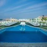 The illuminated swimming pool and sun loungers on the top deck of the Princess Sarah I Nile Cruise.