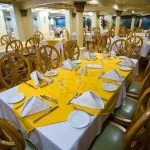 Spacious dining room with elegantly set tables on the Princess Sarah I Nile Cruise.