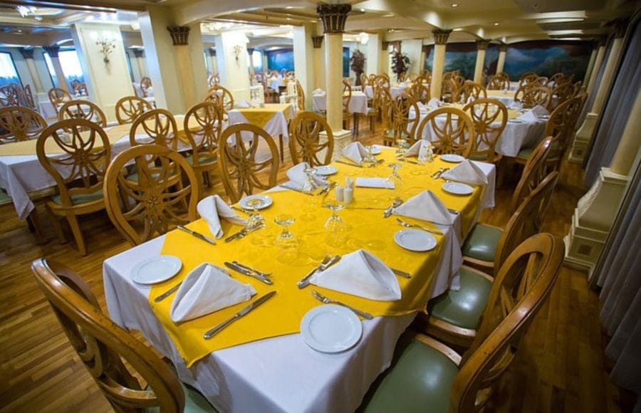 Spacious dining room with elegantly set tables on the Princess Sarah I Nile Cruise.