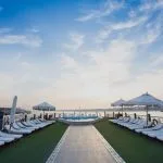 The sun deck of the Princess Sarah I Nile Cruise, with many sun loungers and a sparkling pool.