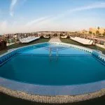 Outdoor swimming pool and sun loungers on the top deck of the Princess Sarah II Nile Cruise.