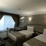 A twin cabin on the Princess Sarah II Nile Cruise, with two single beds.